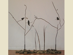 Two steel trees with rocks